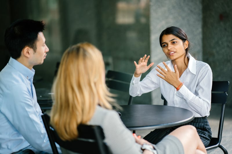 Indian-woman-talking-in-an-interview-in-front-of-two-people-tell-us-about-yourself