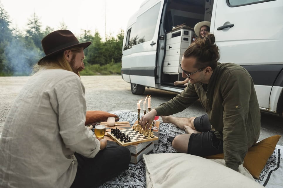 Male-friends-playing-chess-while-spending-leisure-time-by-motor-home-things-to-do-with-your-free-time