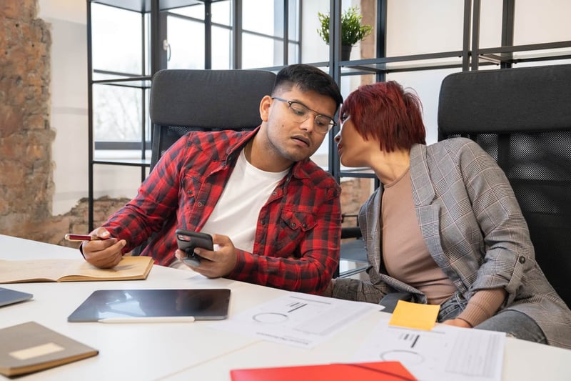 Man-And-Woman-Gossiping-At-Work-toxic-work-environment