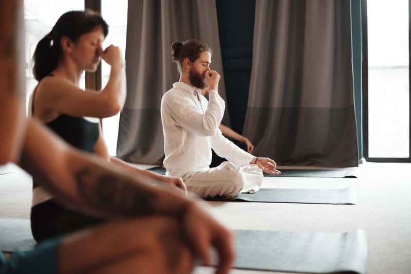 Man-Pinching-Nose-And-Meditating-With-Group-how-to-clear-your-mind