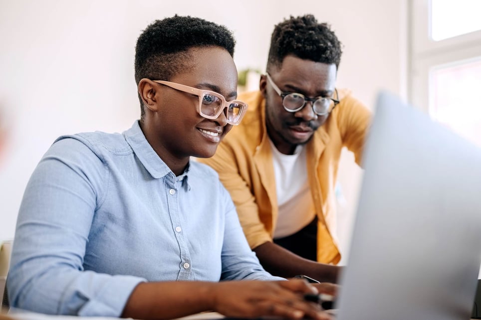 Man-and-woman-coworkers-looking-at-computer-together-personality-test-for-workplace