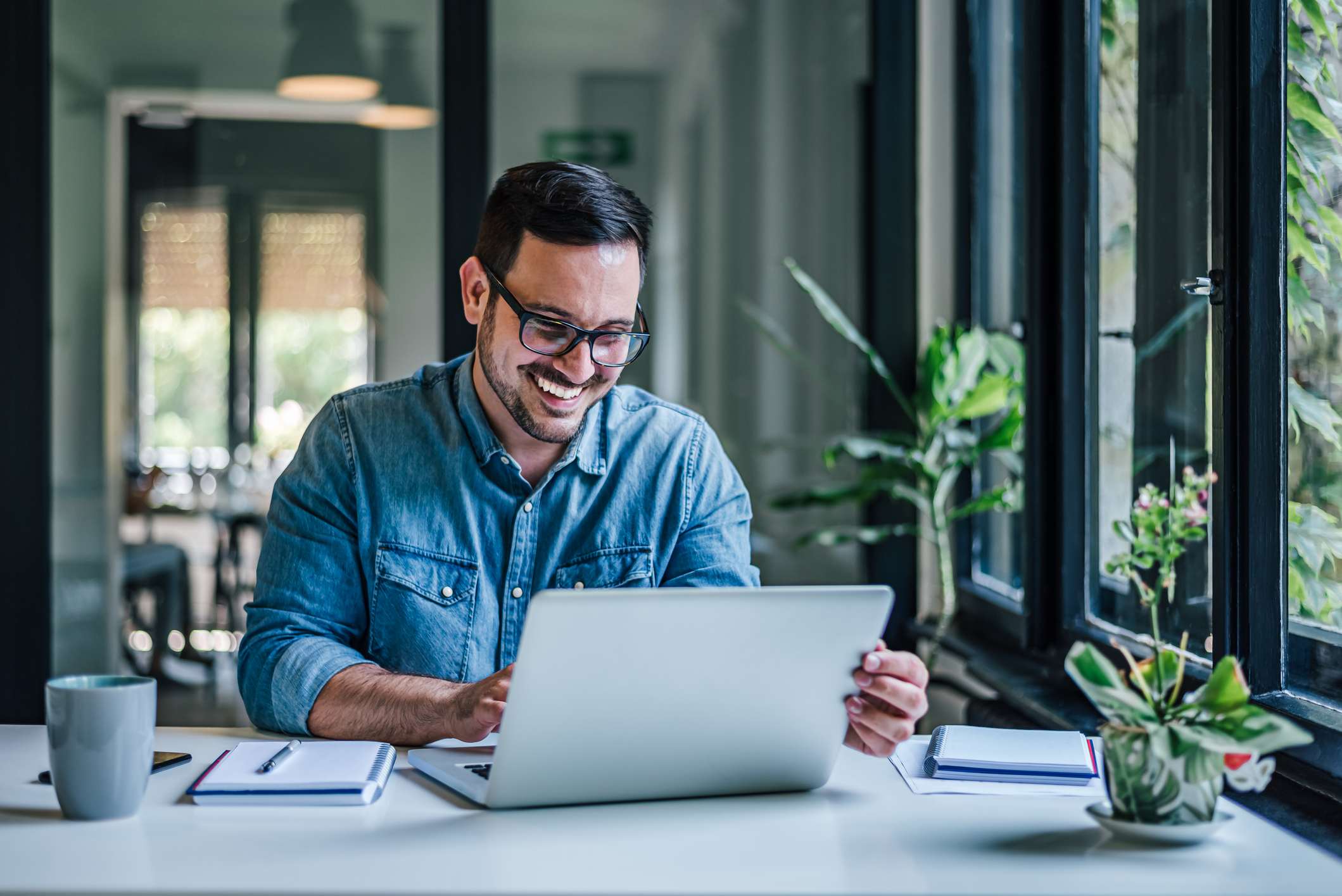 Man-at-home-happy-and-smiling-with-laptop-and-coffee-how-emotions-affect-learning