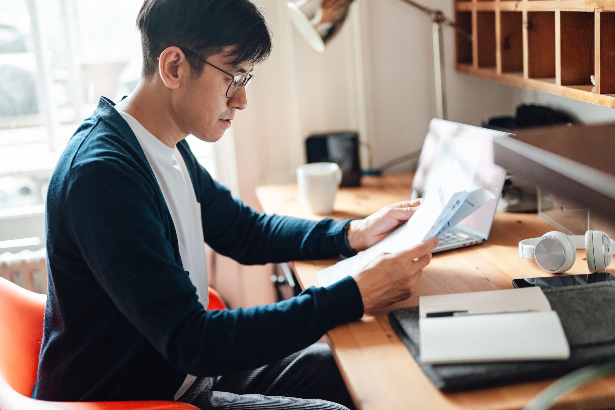 Man-checking-financial-status-after-losing-job-laid-off-vs-fired