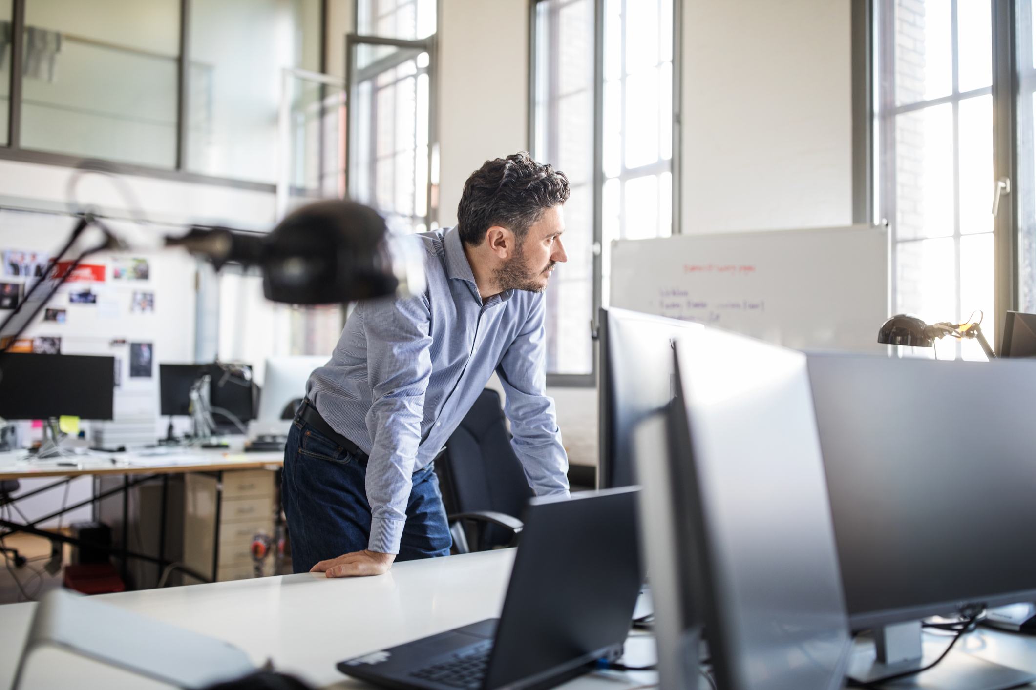 Man-leaning-on-desk-power-poses