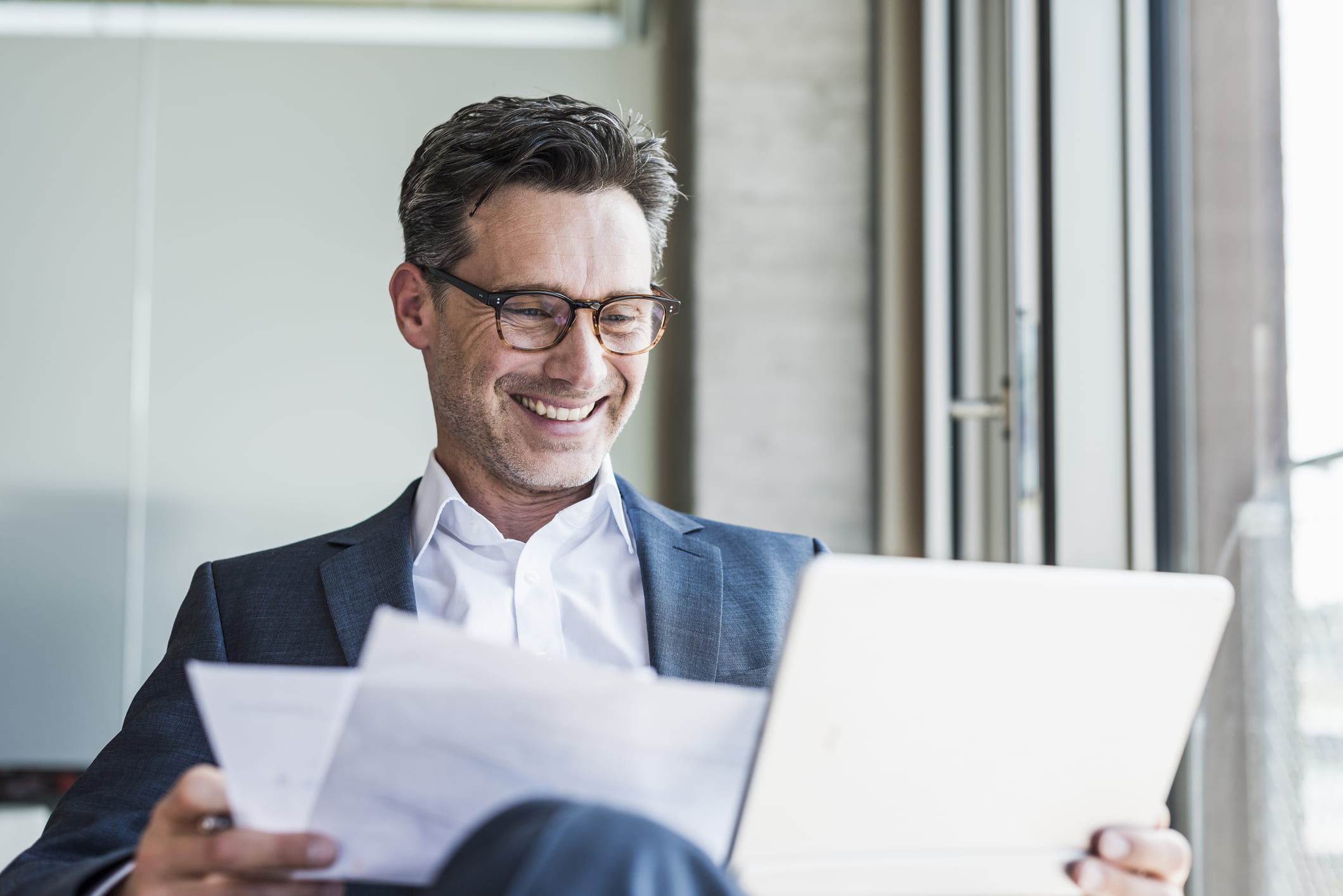 Man-looking-happily-at-stack-of-papers-structured-interview