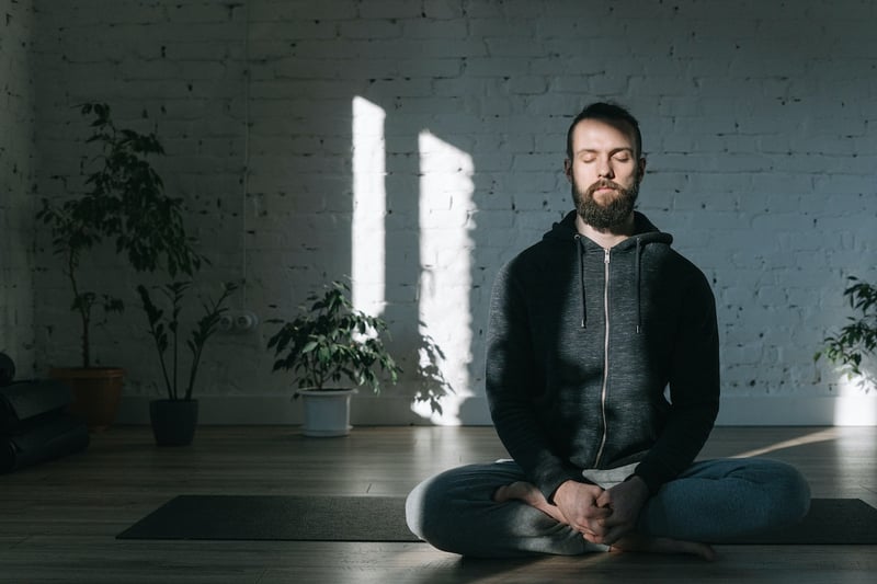 Man-meditating-on-the-floor-alone-how-to-stop-being-self-conscious