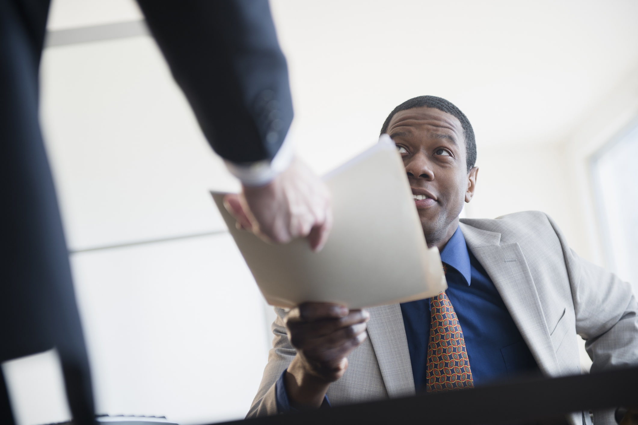 Man-receiving-sealed-folder-with-important-information-employee-poaching