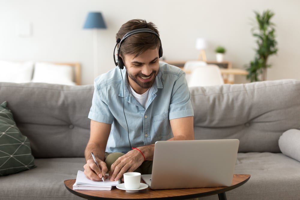 Man-sitting-on-couch-in-living-room-at-home-hard-work-vs-smart-work