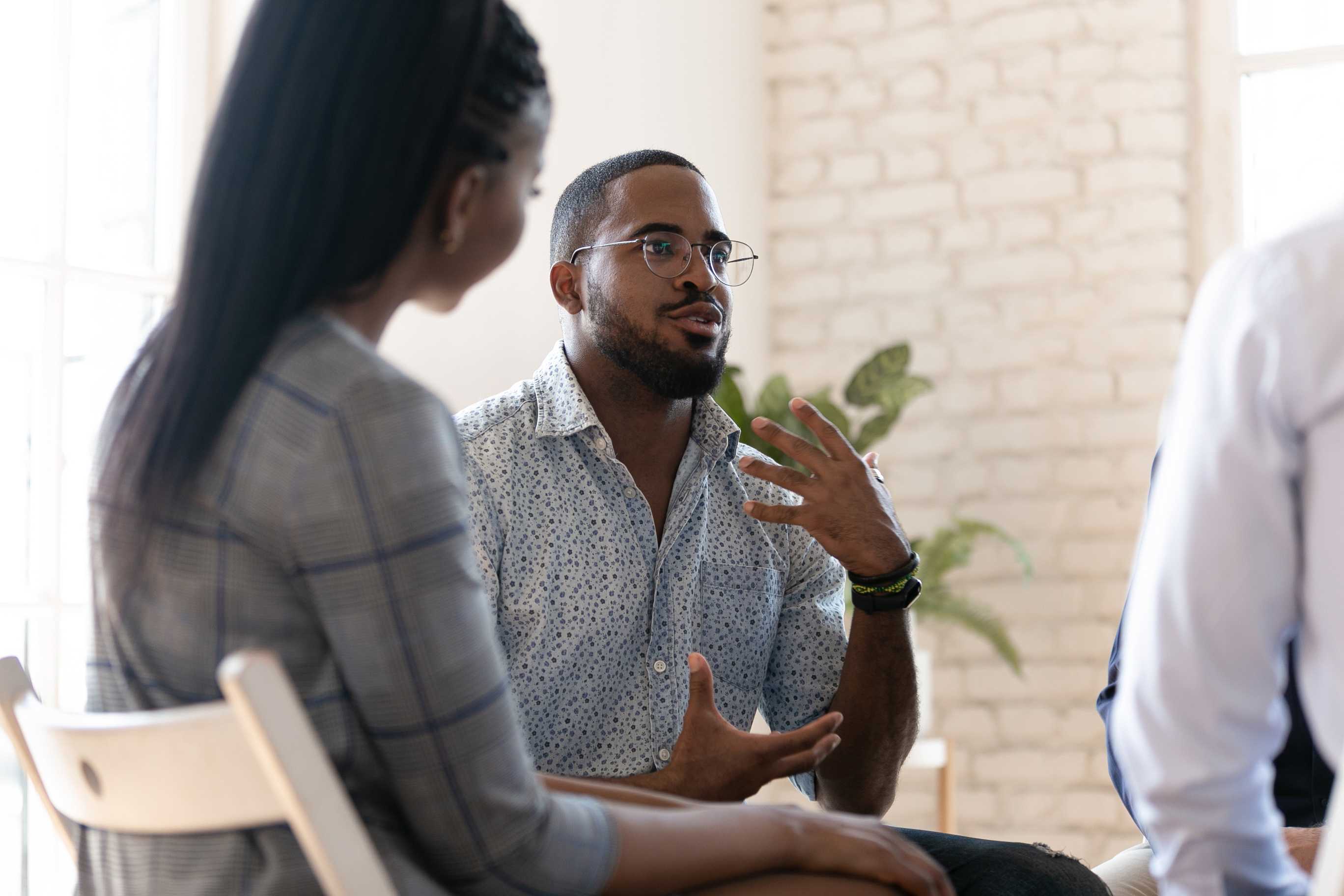 Man-talking-at-group-therapy-session-how-to-stop-self-pity