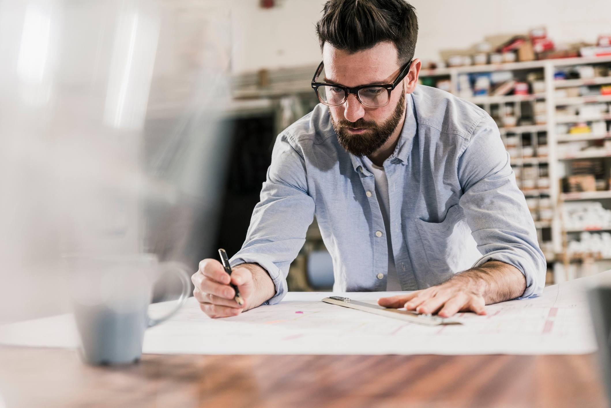 Man-using-ruler-to-draw-something-on-paper-decision-models