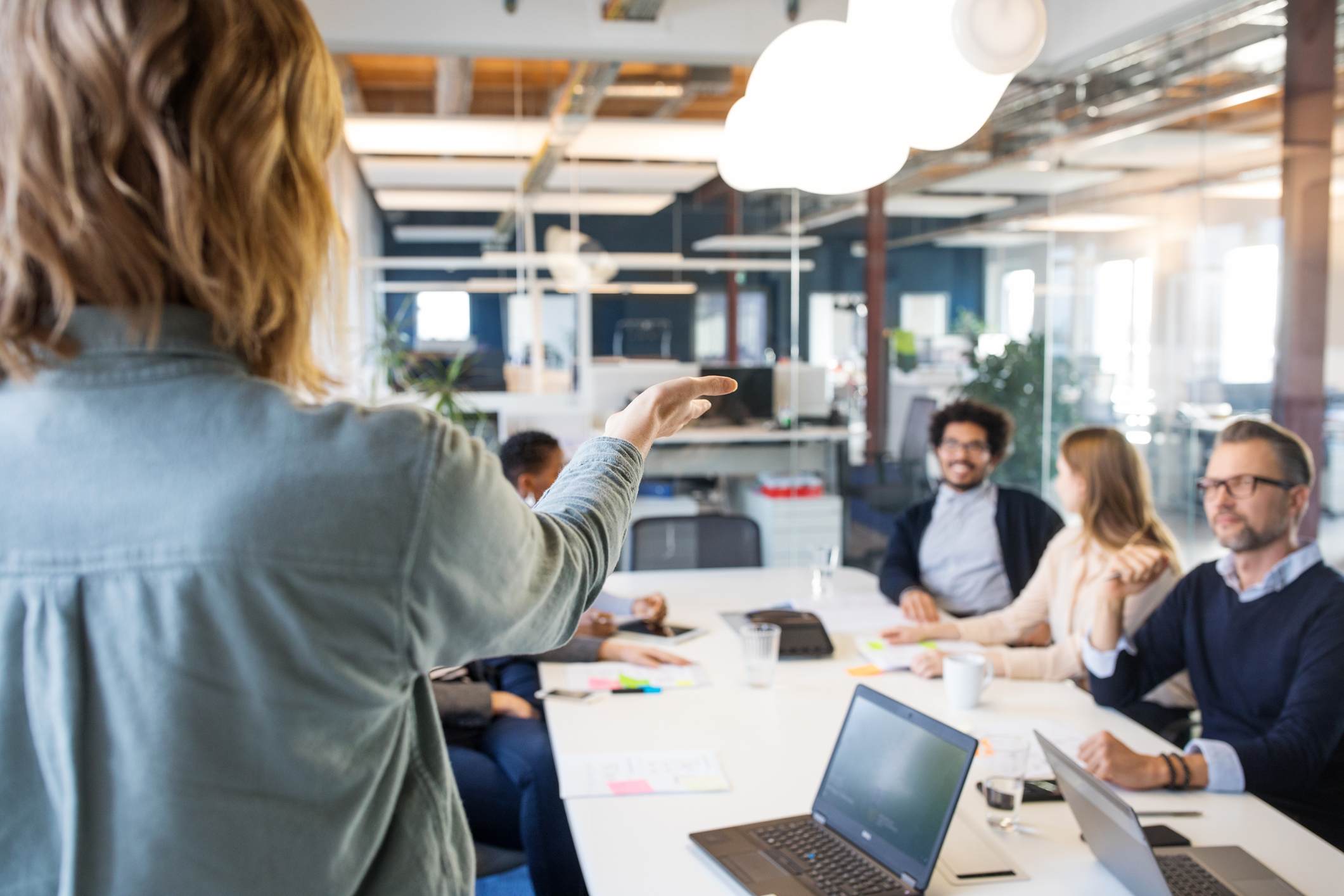 Manager-at-meeting-encouraging-coworker-to-speak-types-of-innovation