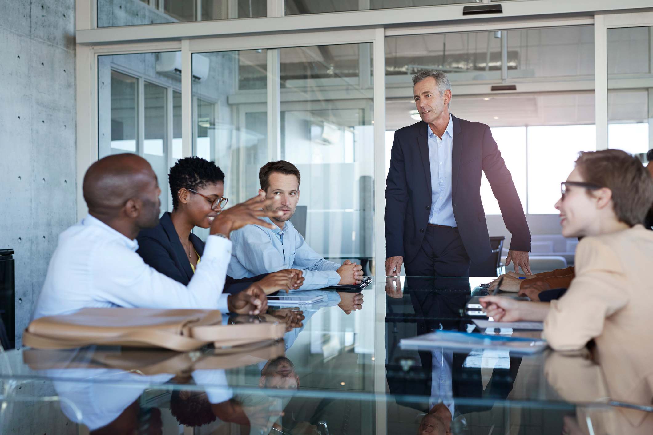 Manager-listening-to-coworker-at-meeting-favoritism-in-workplace