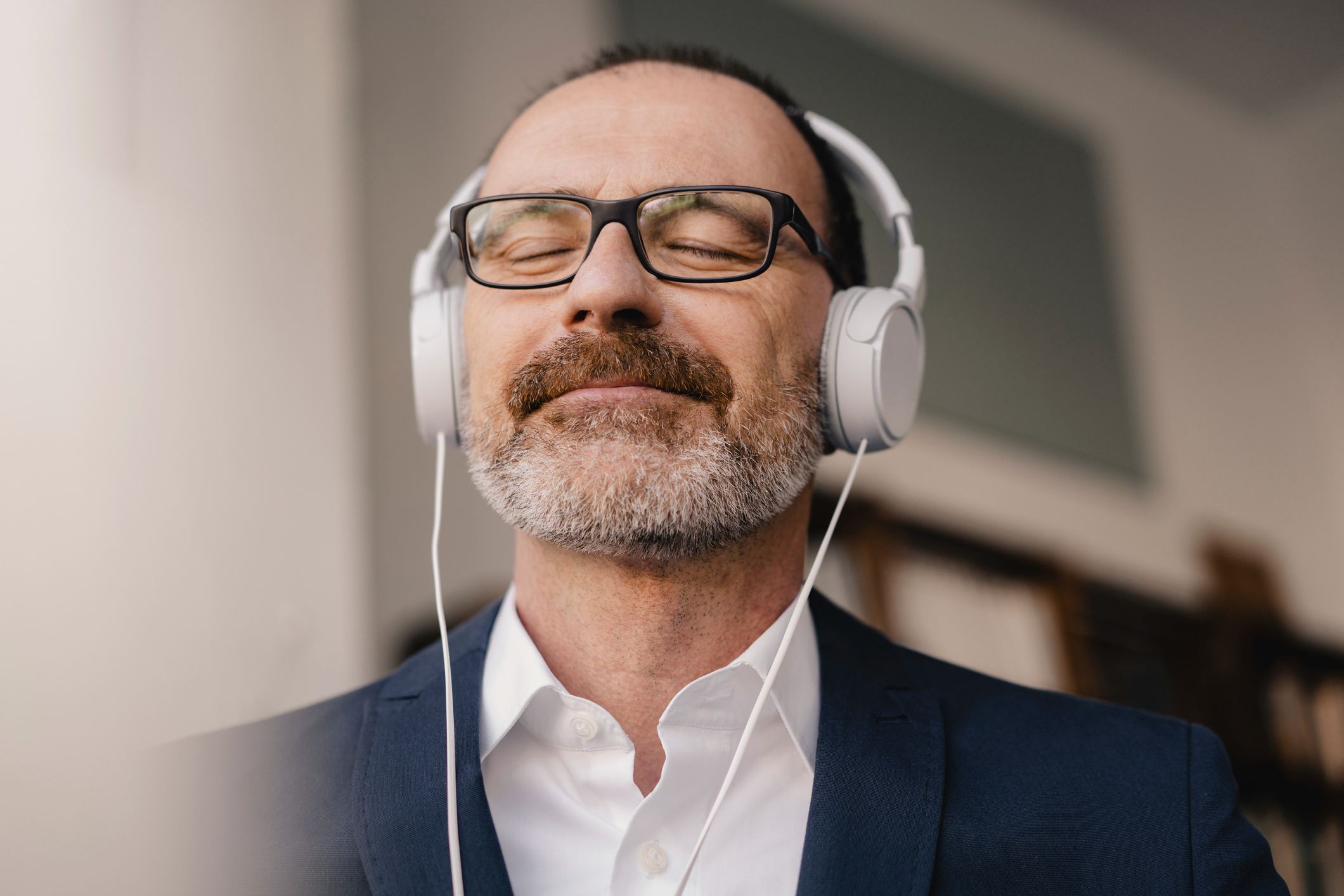 Mature-businessman-with-closed-eyes-listening-to-music-mindfulness-activities