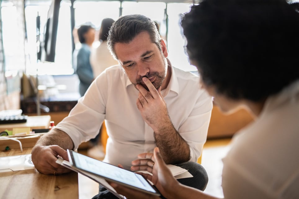 Mature-man-looking-at-a-tablet-with-coworker-10-interview-skills