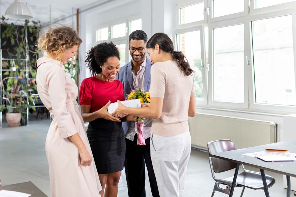 Men-and-woman-celebrating-advancement-in-office-kudos-example