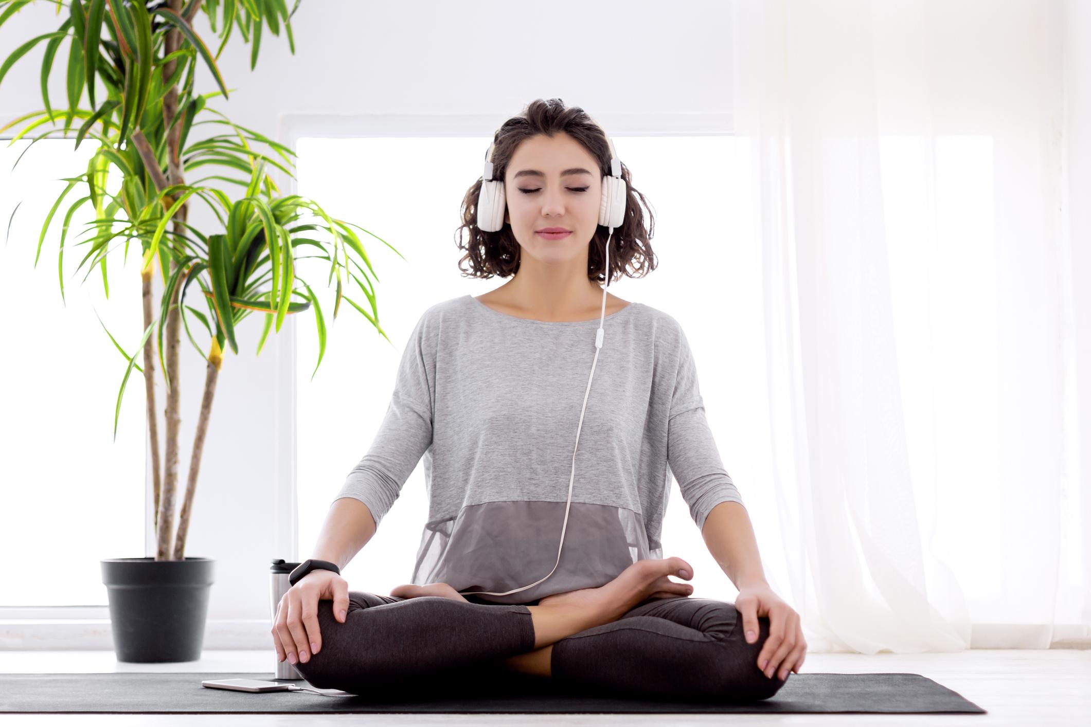 Modern-woman-with-headphones-sitting-music-relaxation-for-stress