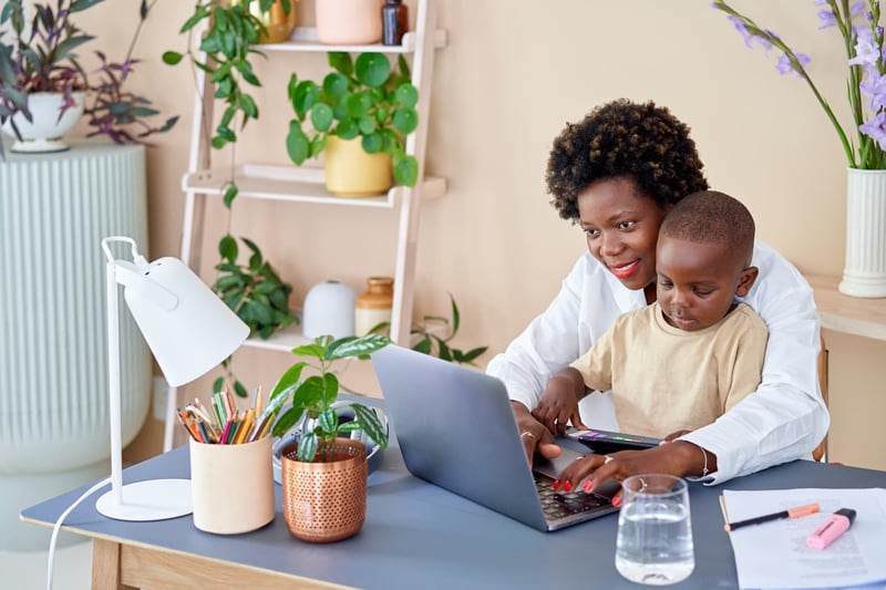 Mother-At-Home-Working-With-Her-Kid-work-from-home-setup