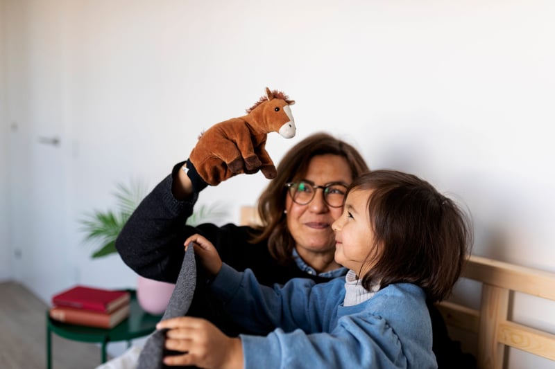 Mother-and-daughter-playing-with-puppets-on-bed-1