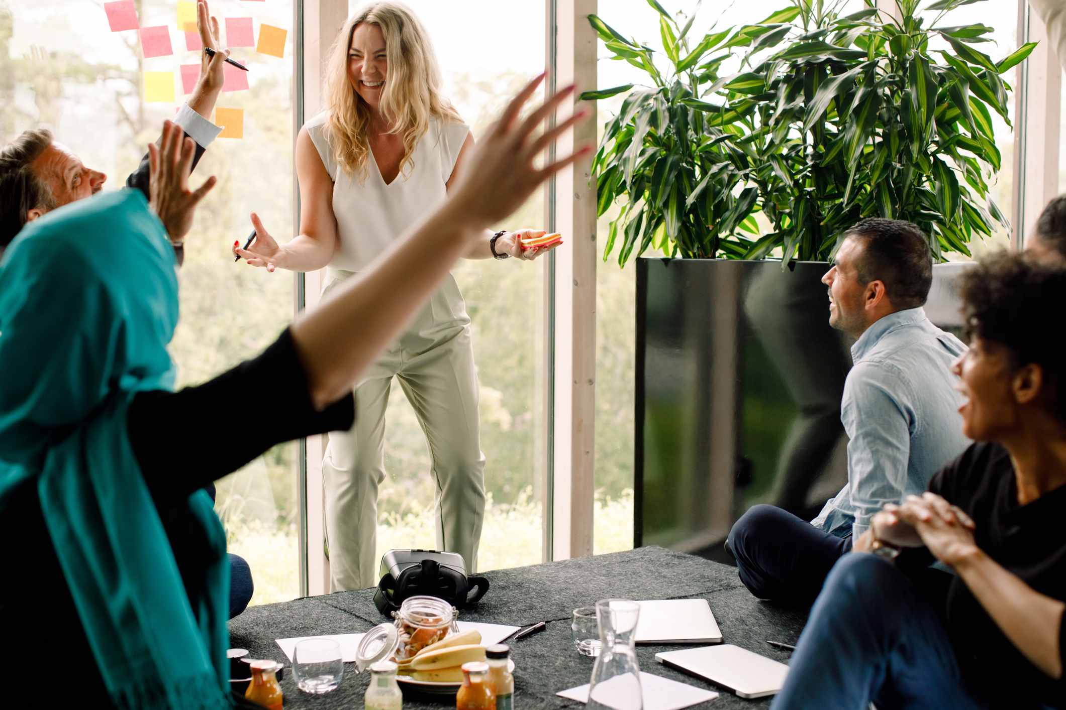 Multi-ethnic-business-professionals-cheering-during-kick-off-meeting-quotes-to-motivate-a-team