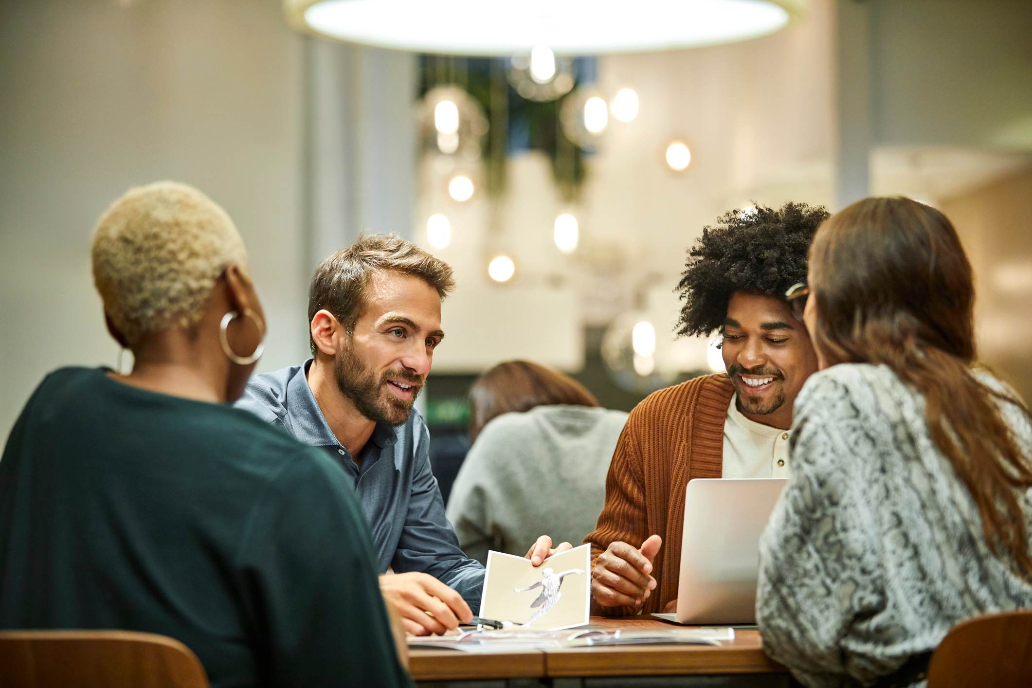 Multi-ethnic-coworkers-discussing-in-office-active-listening