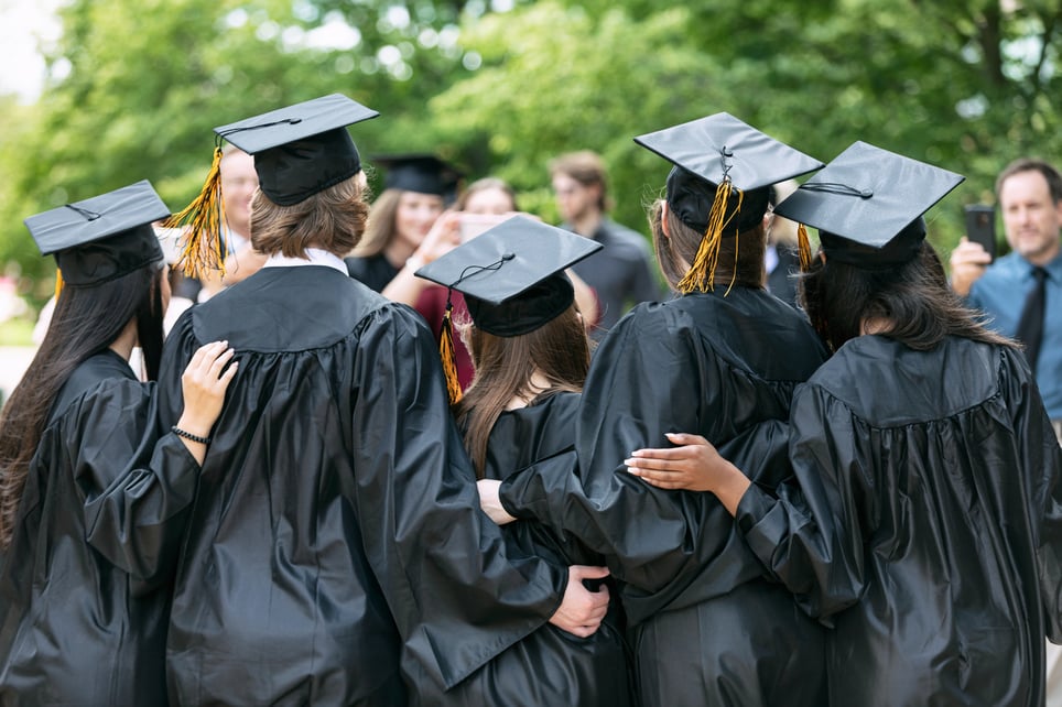 Multi-ethnic-group-college-graduates-on-campus-should-i-go-to-grad-school