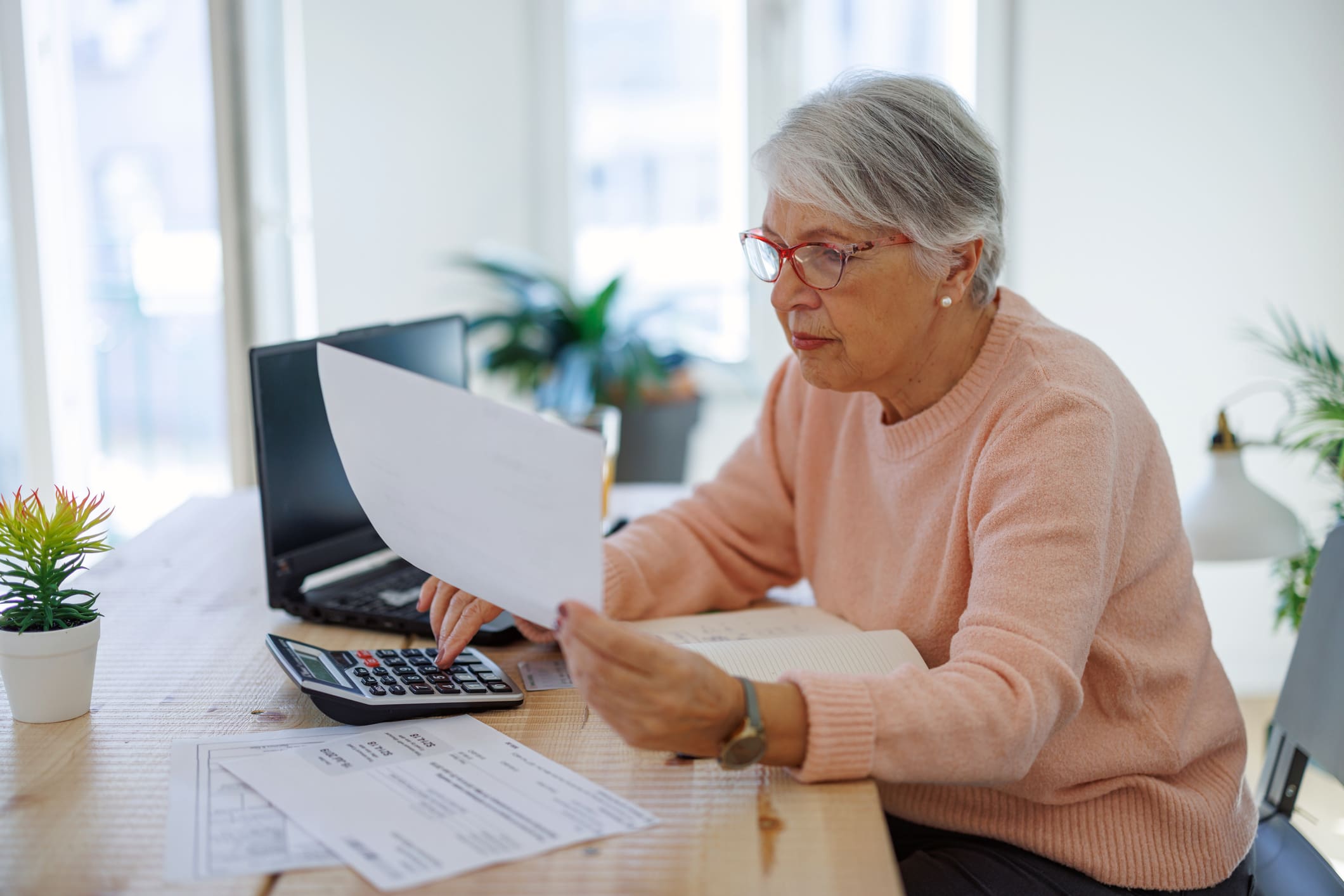 Older-woman-calculating-budget-compensation-plan