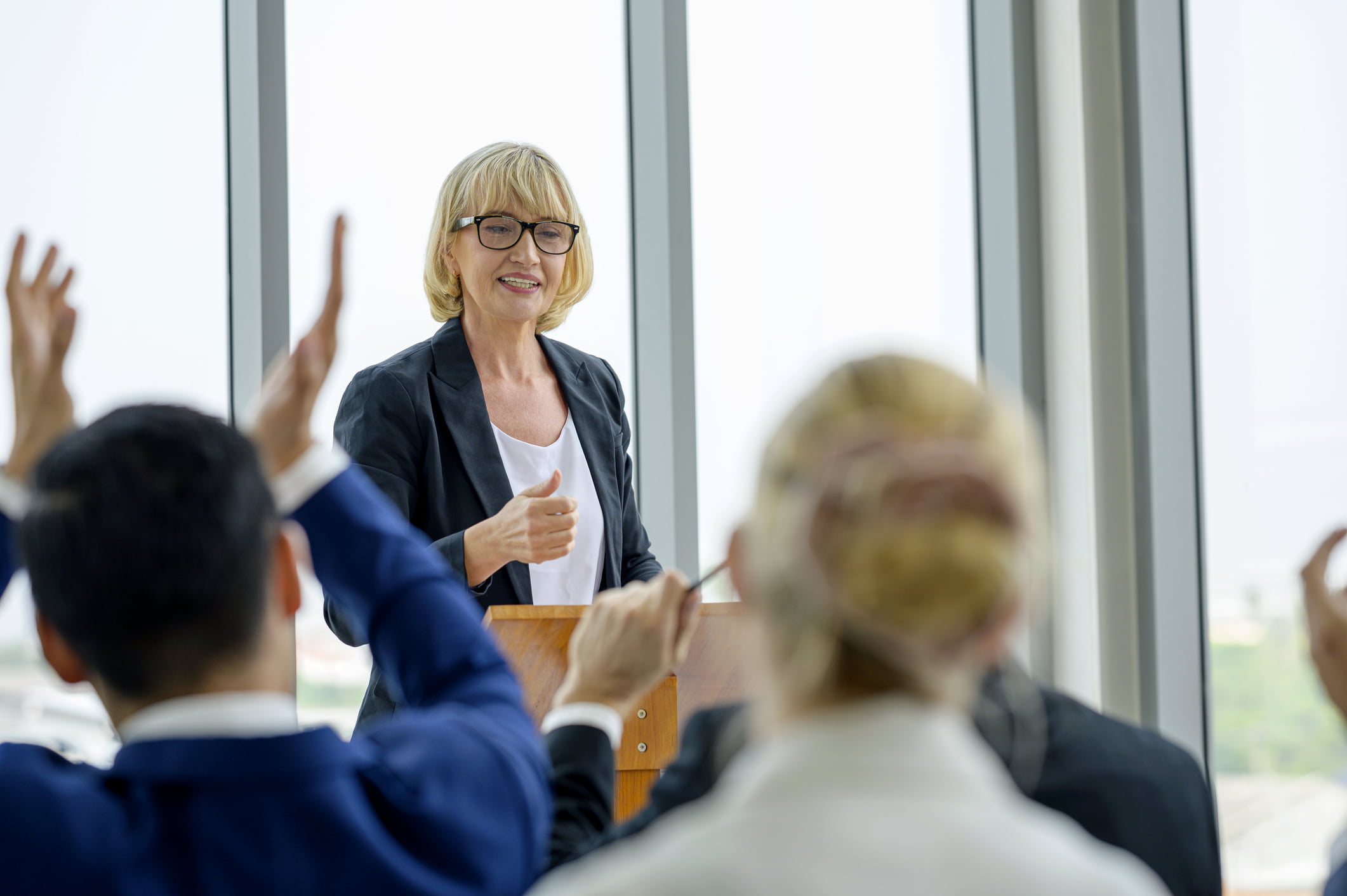 Older-woman-giving-seminar-to-group-tacit-knowledge