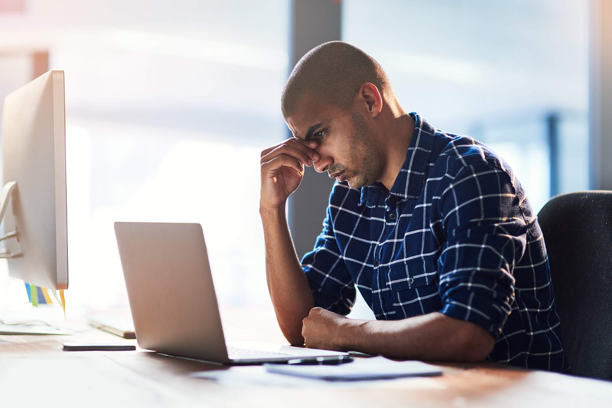 Overwhelmed-man-at-work-signs-your-coworker-is-threatened-by-you-and-how-to-deal-with-it