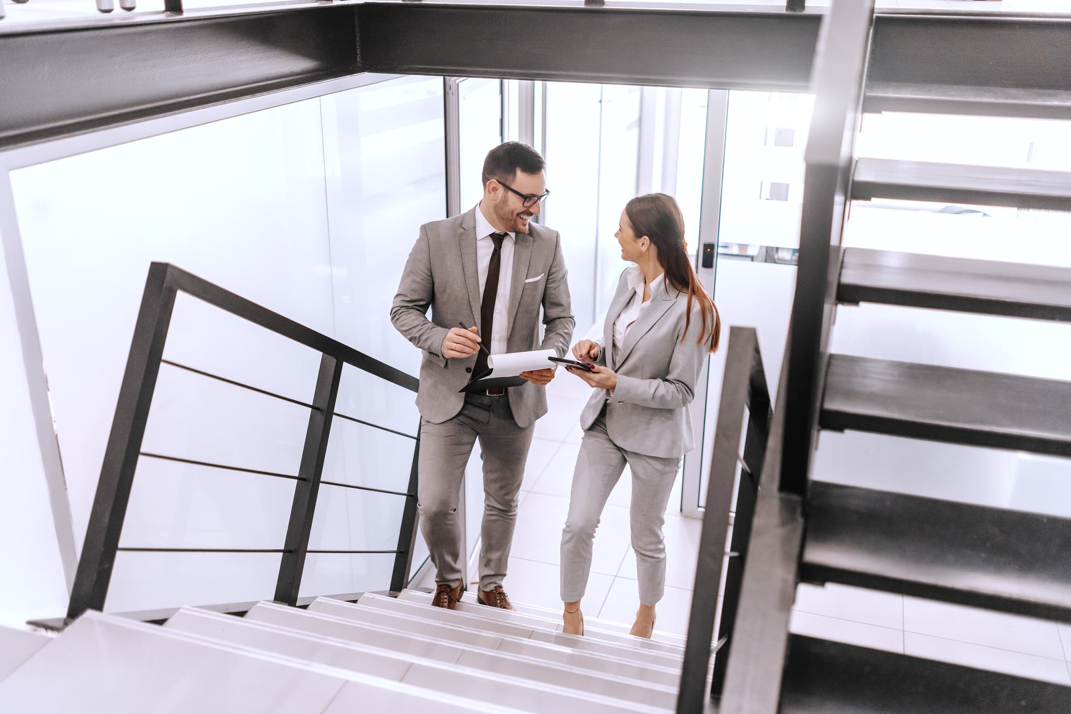 Pair-of-elegant-coworkers-walking-up-the-stairs-internal-candidate