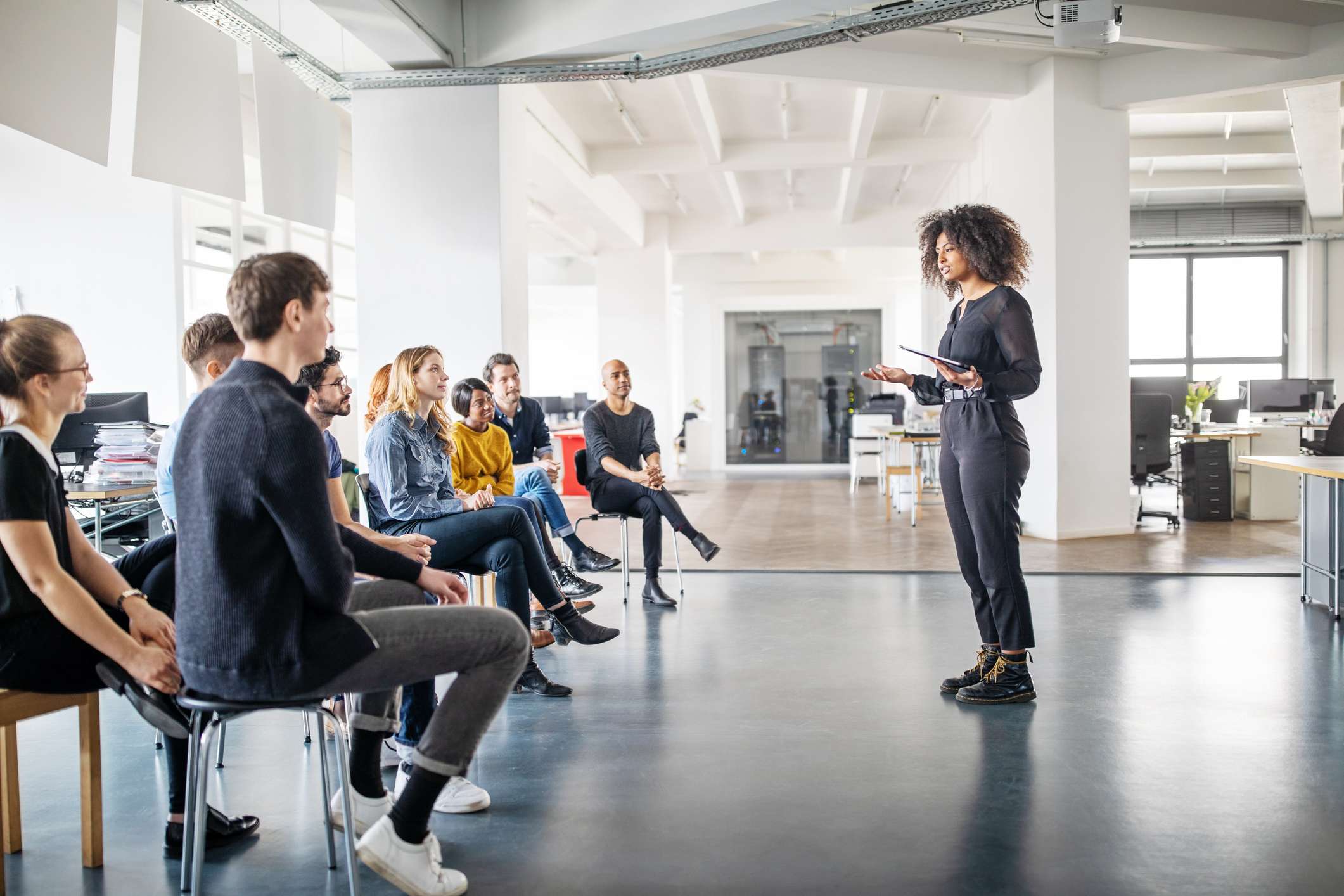 Professional-woman-giving-speech-at-a-work-meeting-how-to-write-a-linkedin-summary