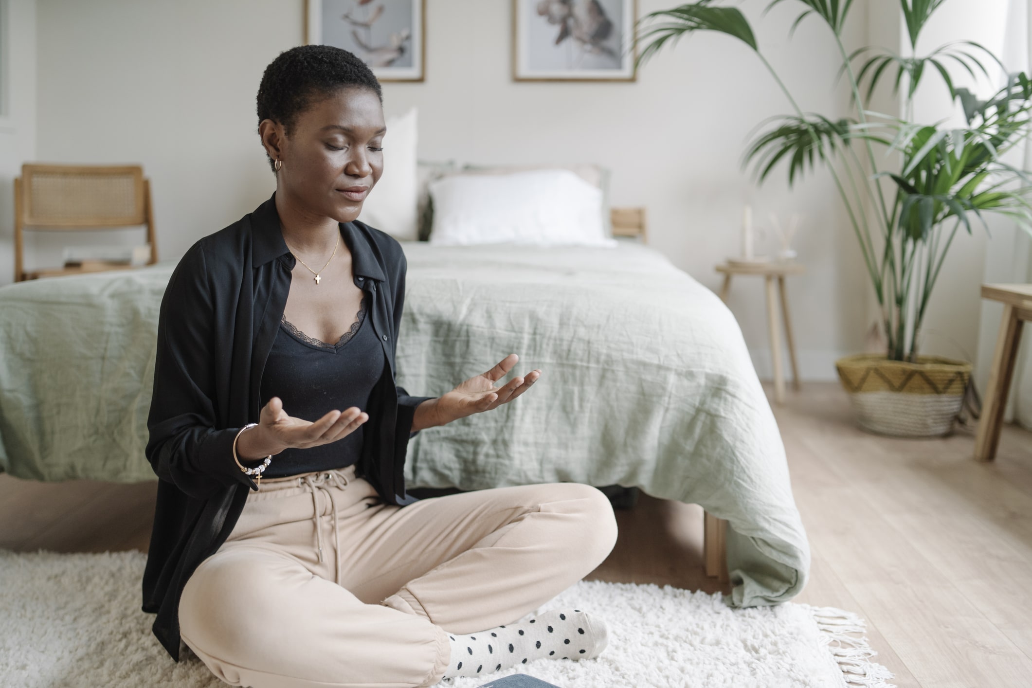 Relaxed-woman-sitting-on-the-floor-practicing-meditation-purpose-of-sadness