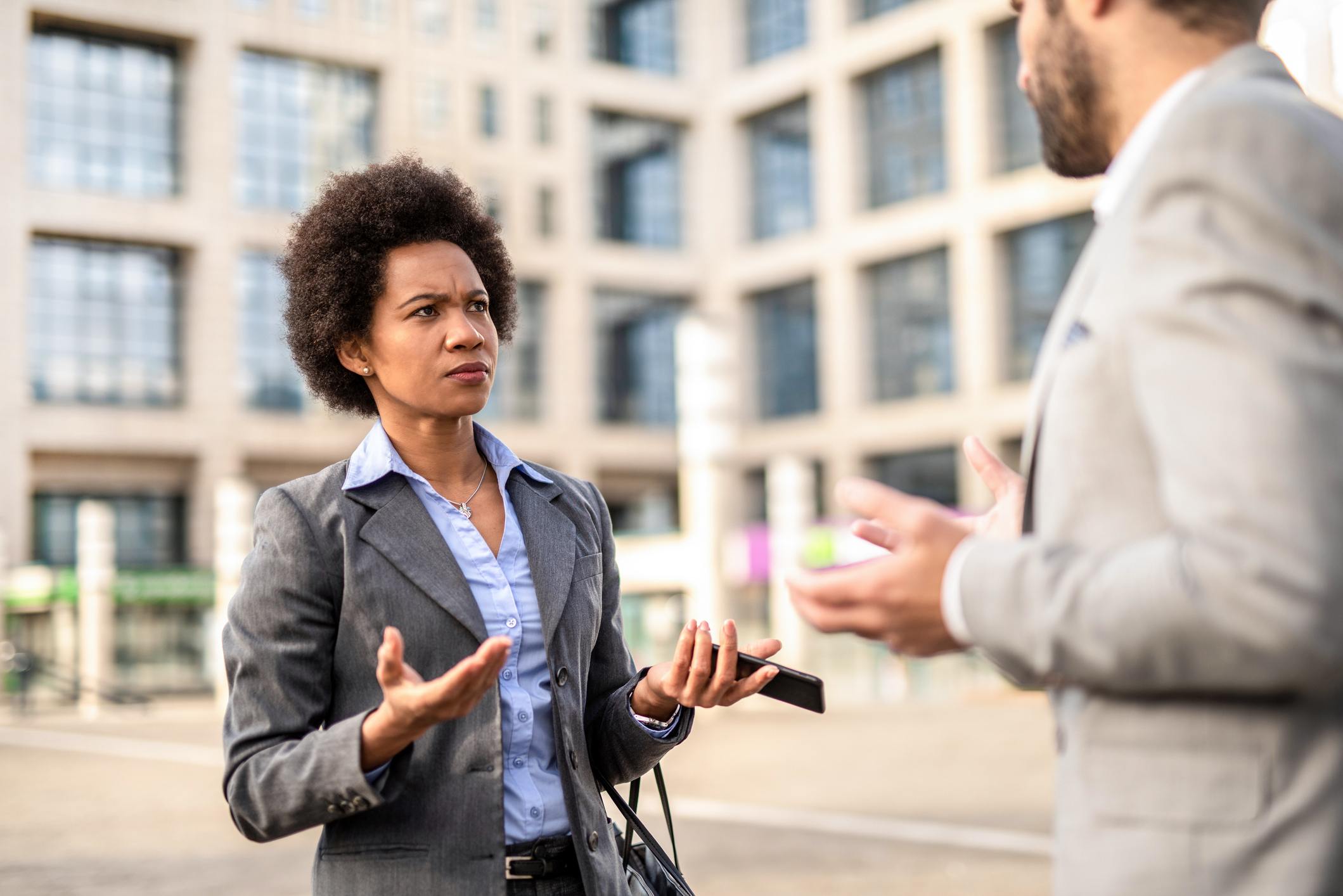 Serious-woman-talking-to-coworker-communication-styles-in-the-workplace