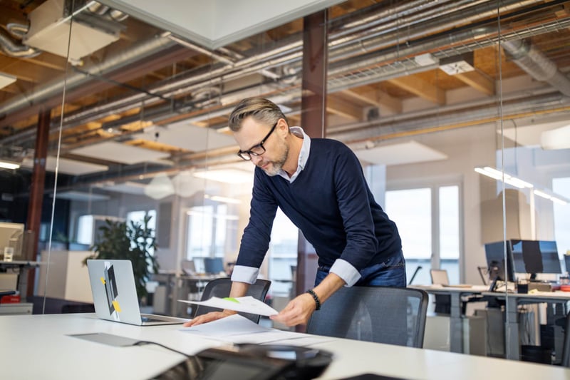 Shot-of-mid-adult-businessman-standing-in-office-fear-of-disappointing-others