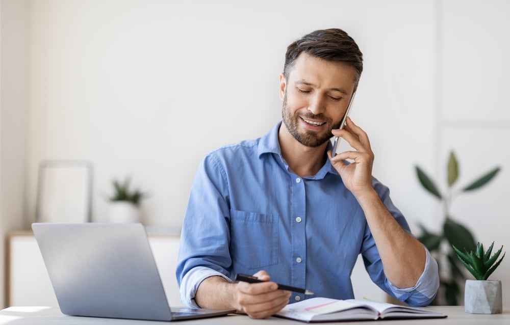 Smiling-Businessman-Taking-Notes-hard-work-vs-smart-work