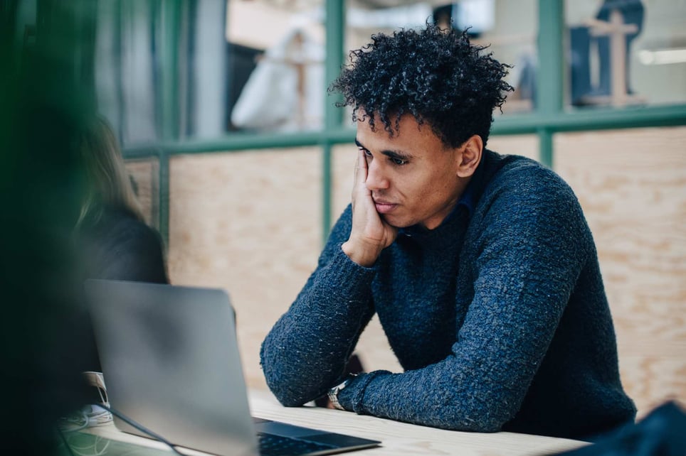 Stressed-man-sitting-in-front-of-computer-is-it-better-to-be-fired-or-quit