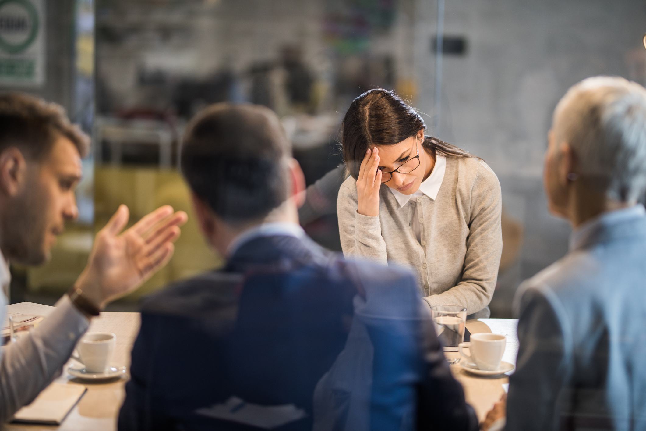 Stressed-woman-in-the-middle-of-managers-meeting-is-it-better-to-be-fired-or-quit