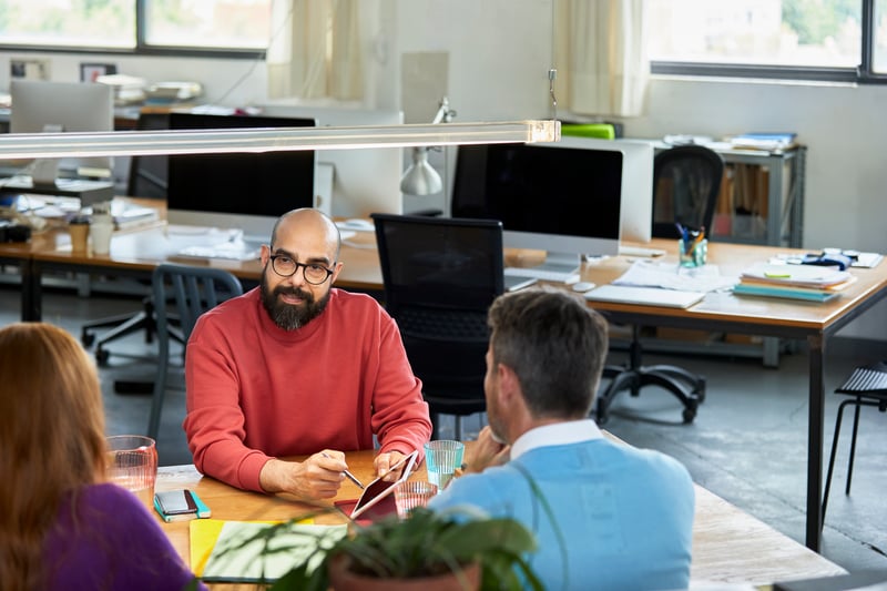 Teams-Meeting-Gathered-By-The-Table-how-to-become-a-manager