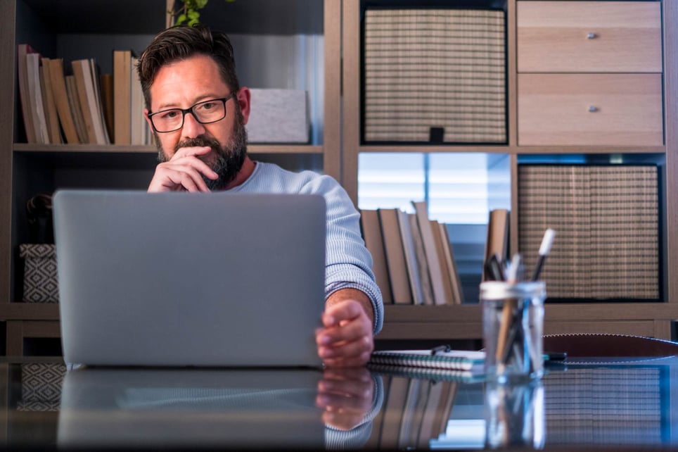 Thoughtful-man-looking-at-his-laptop-how-to-respond-to-a-job-rejection-email