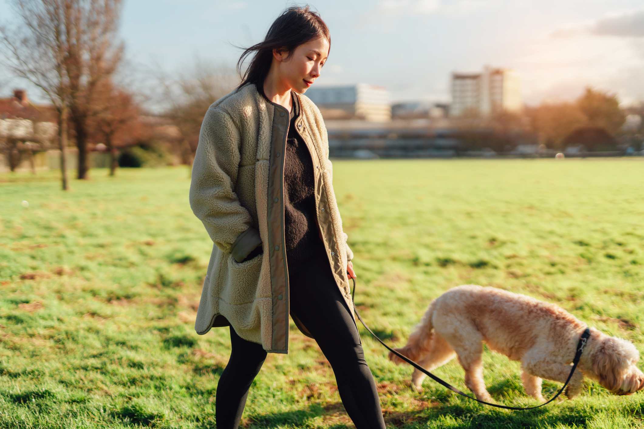 Thoughtful-woman-going-on-a-walk-outside-with-her-dog-crying-at-work