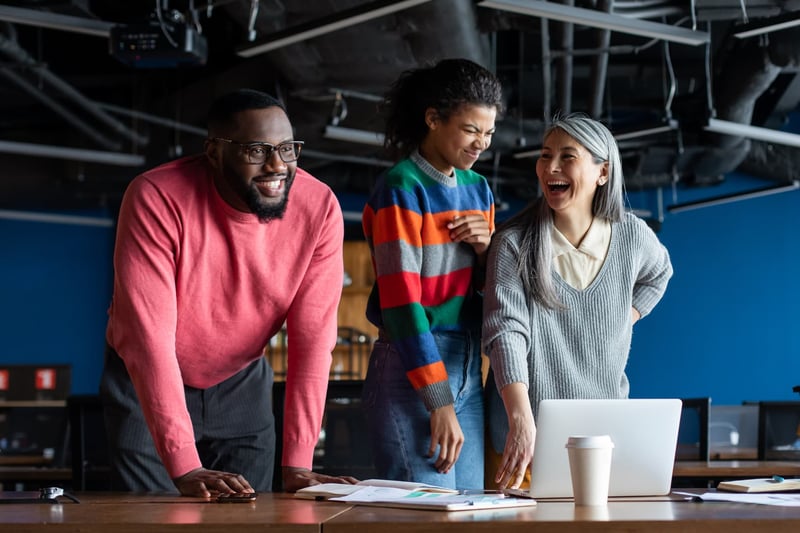 Three-People-Smiling-In-Office-what-makes-a-good-team