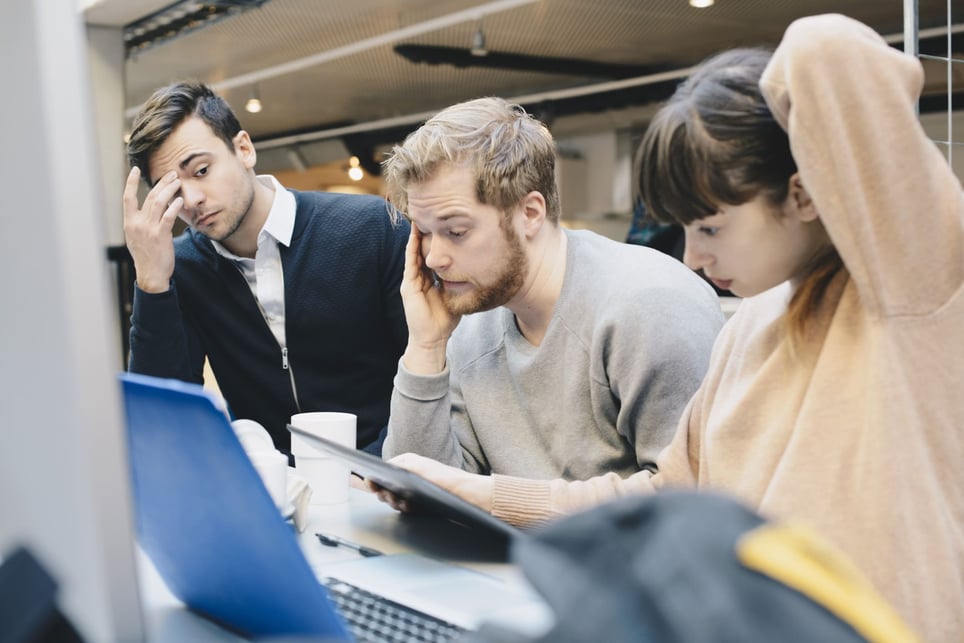 Three-burnt-out-coworkers-stressed-over-work-toxic-productivity