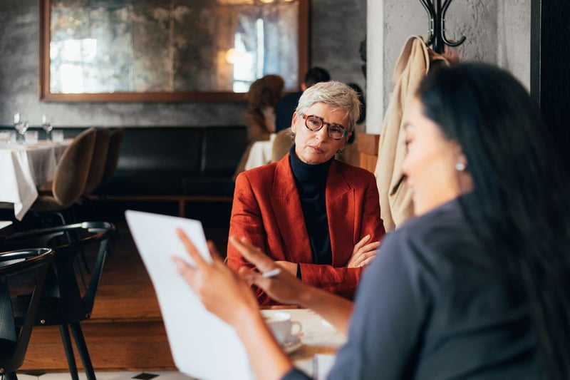 Two-Women-Having-Meeting-how-to-fire-someone-nicely