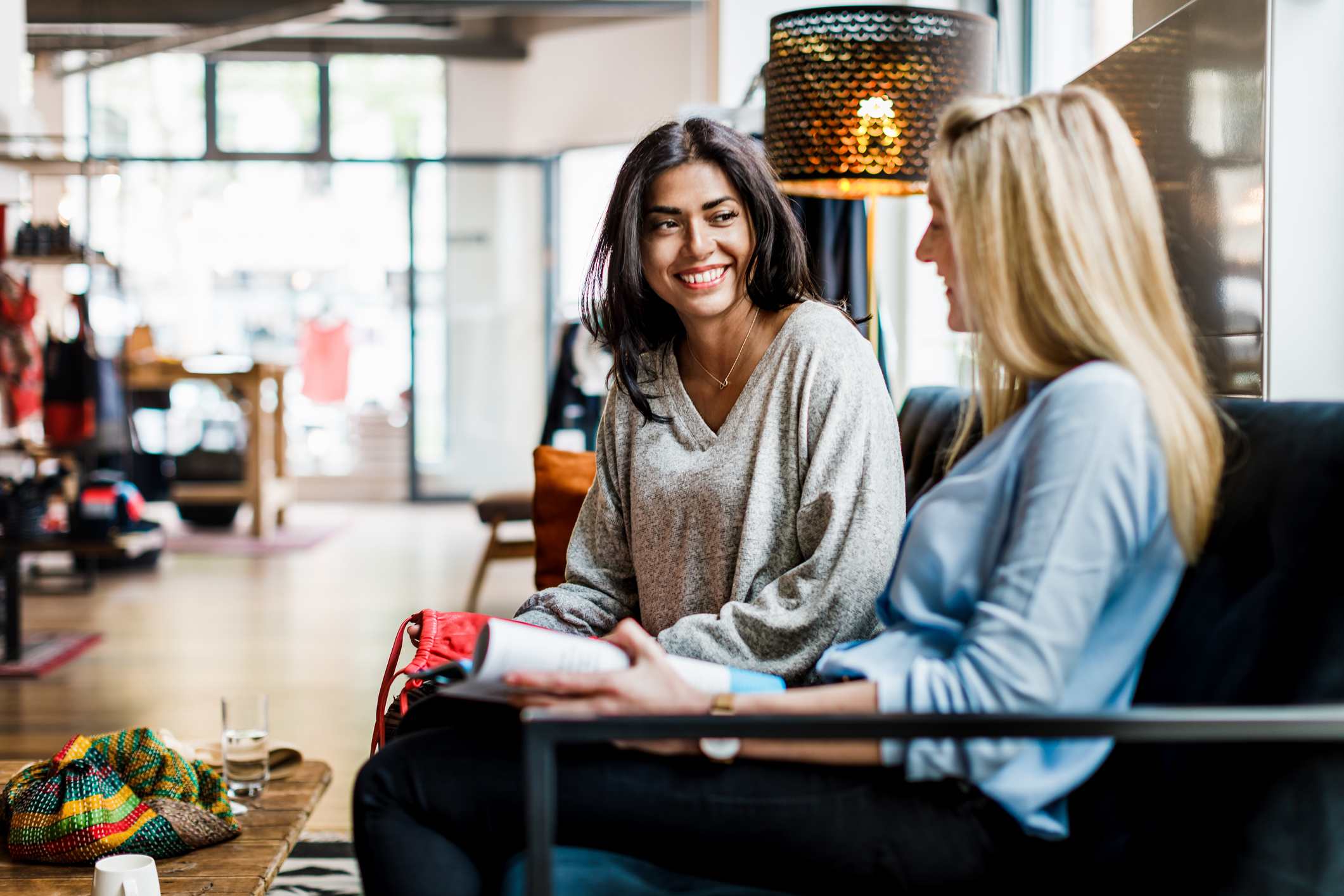 Two-Women-Sitting-Down-Taking-A-Break-From-Shopping-active-listening