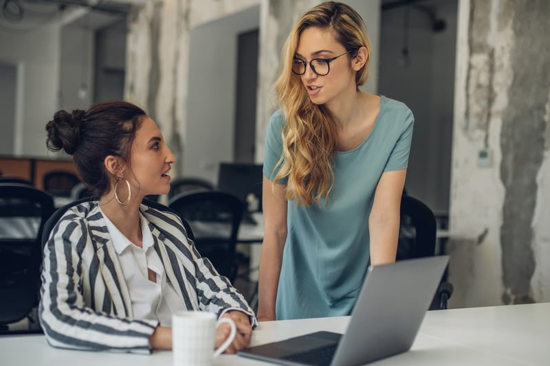 Two-businesswomen-discussing-in-the-office-1