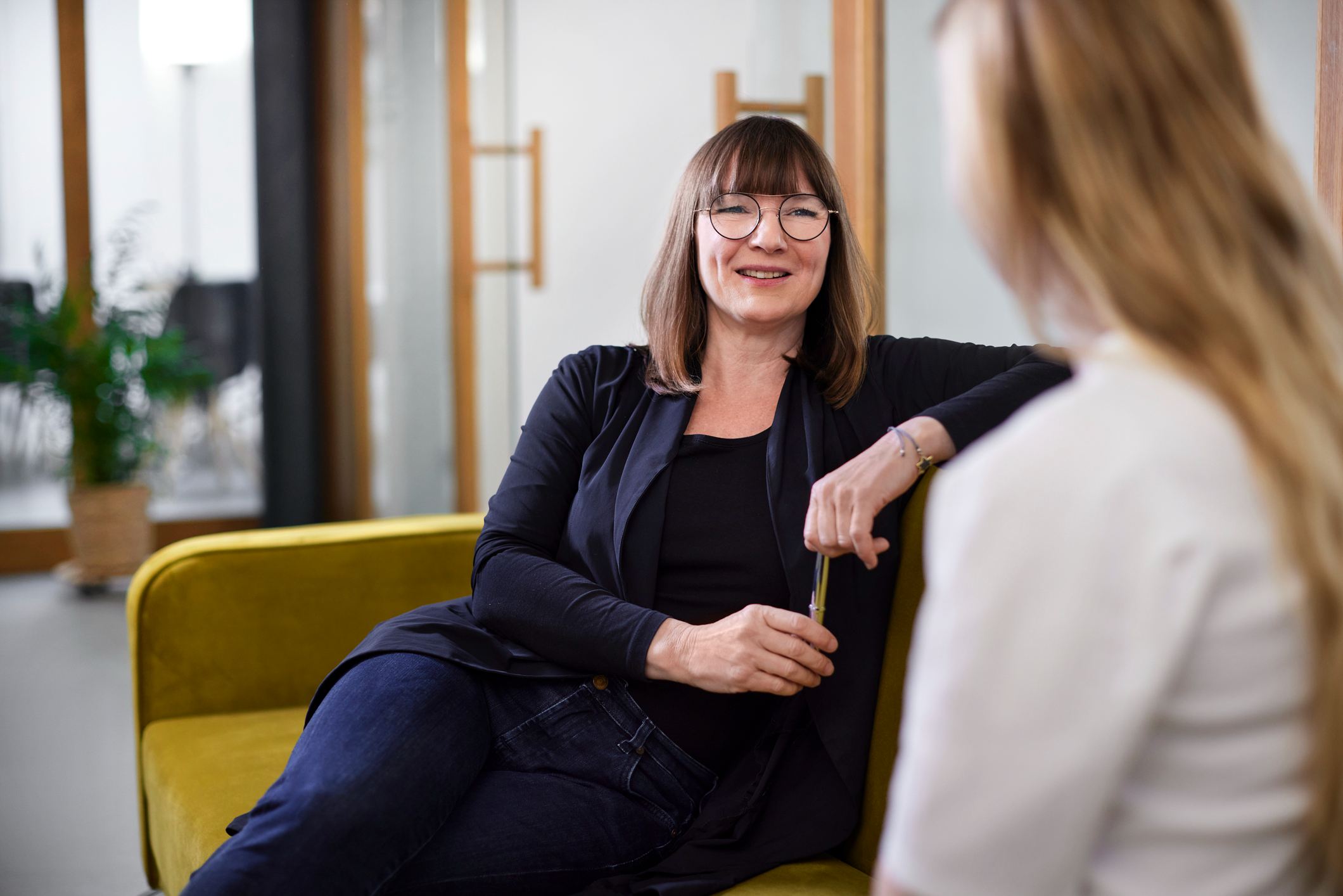 Two-businesswomen-talking-on-couch-why-do-you-want-this-job