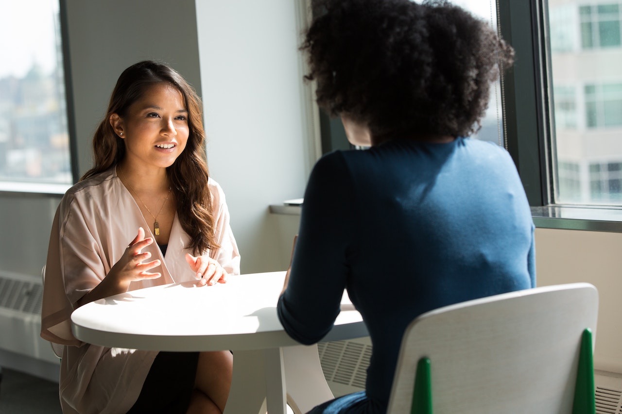 Two-coworkers-talking-at-meeting-why-do-you-want-to-be-a-supervisor