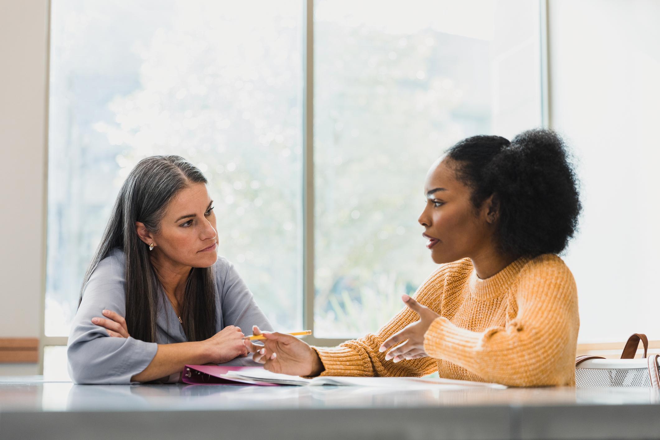 Two-friends-talking-and-giving-advice-anchoring-bias