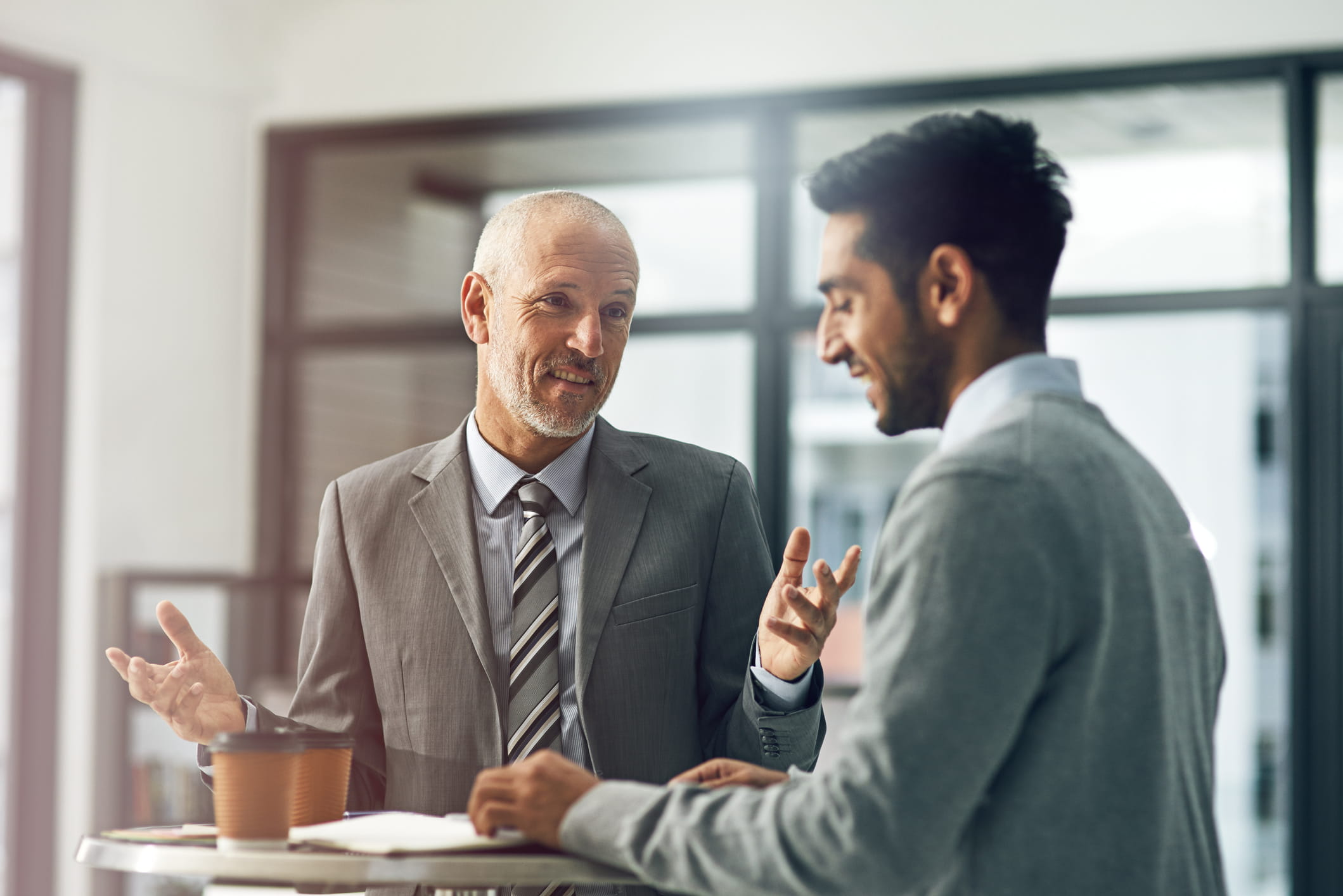 Two-men-having-happy-offboarding-conversation-different-type-of-resumes