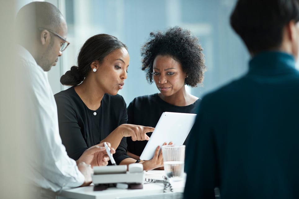 Two-recruiters-looking-at-resume-on-tablet-interview-bias