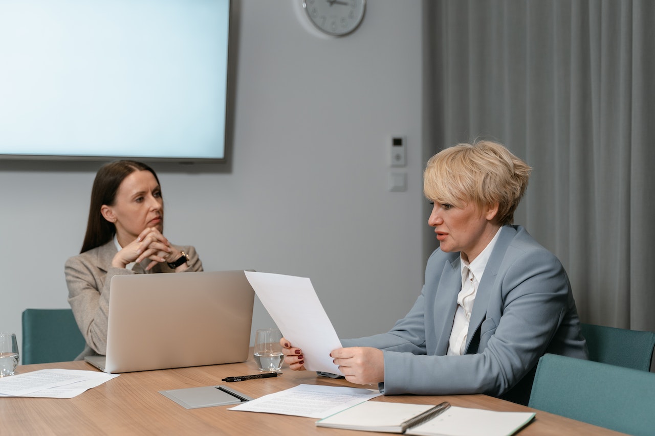 Two-women-sitting-at-table-with-laptop-at-office-relationship-building-skills-examples